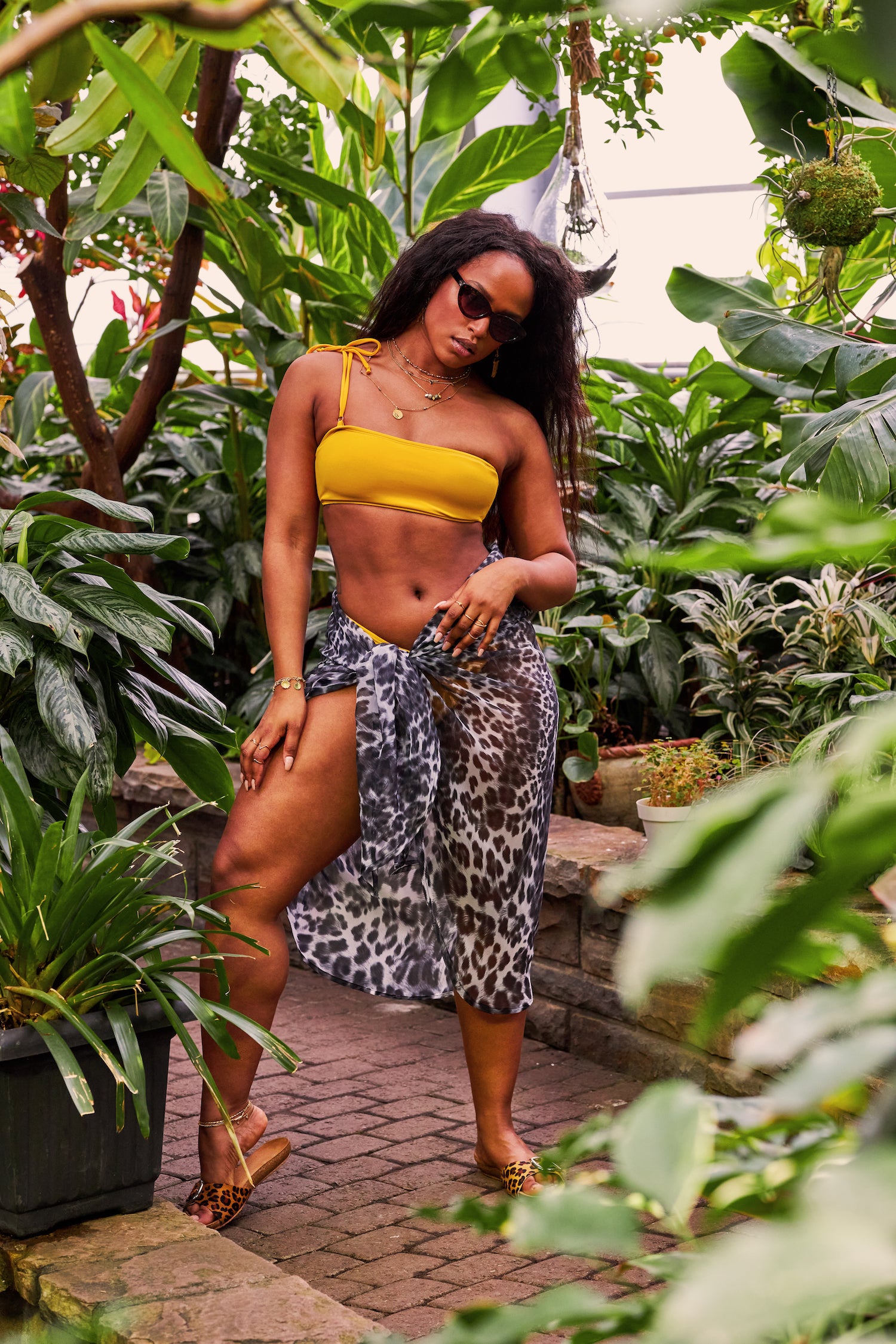 Women wearing yellow bandeau bikini set with leopard printed wrap cover up