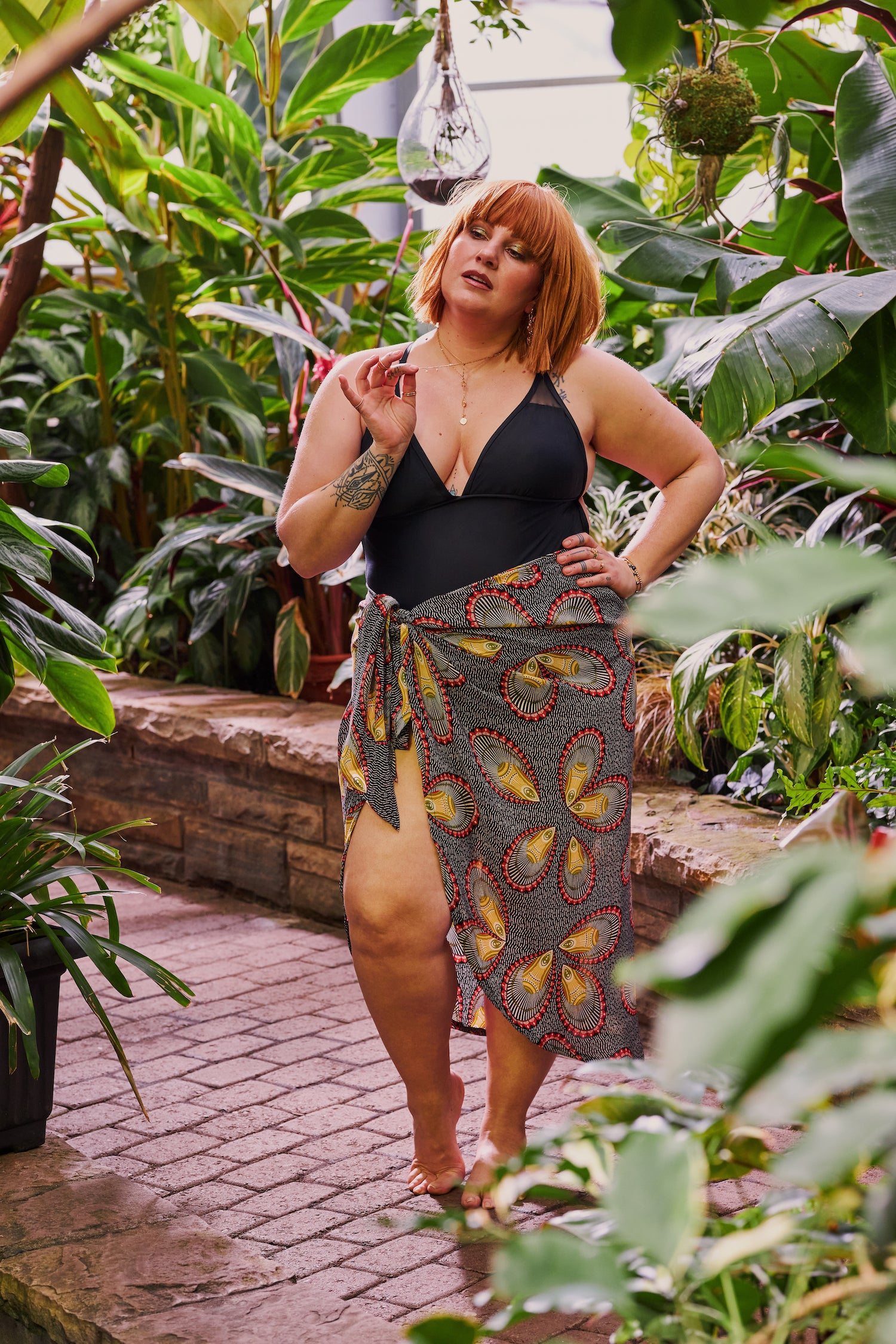 Women wearing black one piece bathing suit with wrap cover up