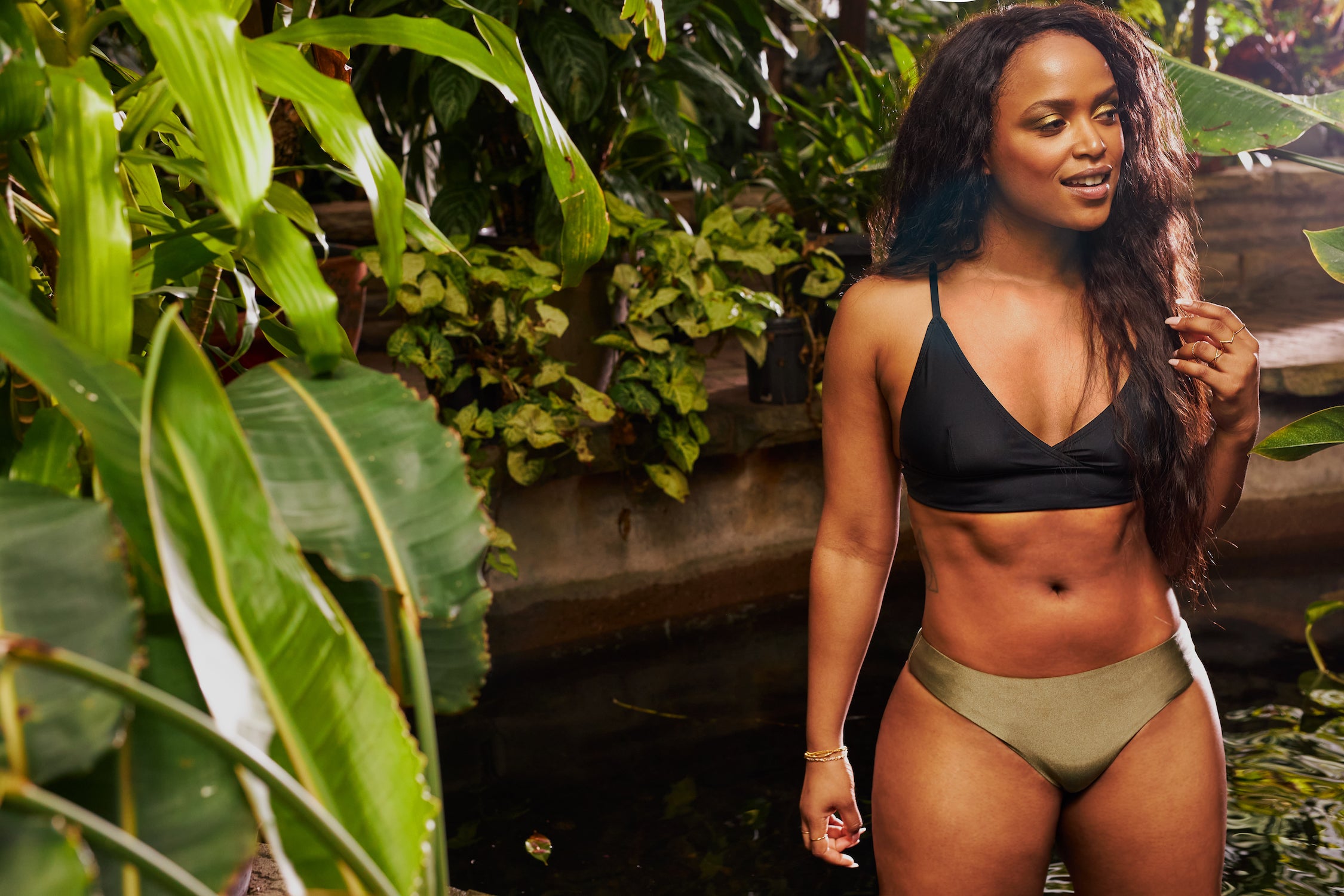 Women wearing reversible bikini bottom in a shinny khaki and adjustable black top