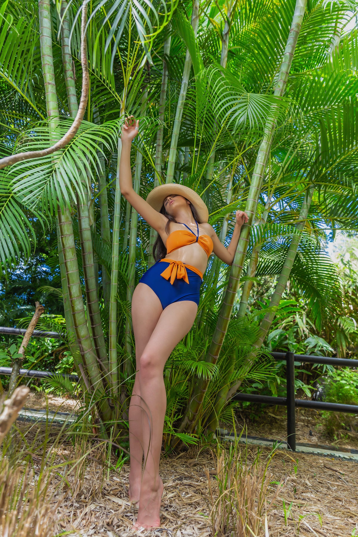 Orange bandeau top and navy blue high waist bikini bottom made of recycled fibres fabric 