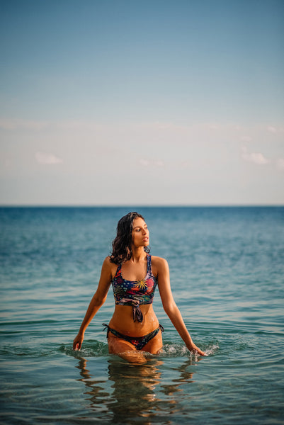 Women walking in ocean wearing flower print bikini set